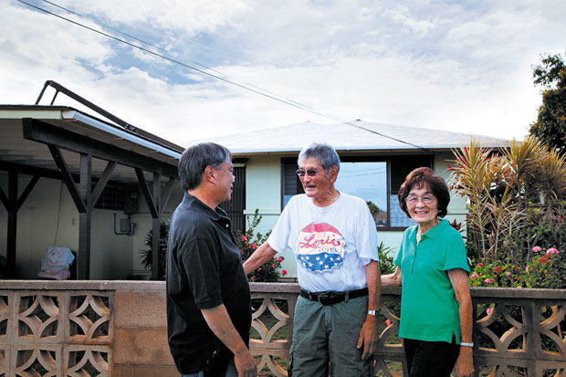 President and Founder Bruce Ekimura (left), discusses a recently purchased PV system with satisfied clients.