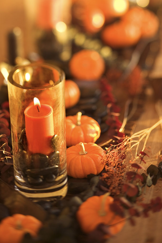Candle and miniature pumpkins